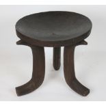 An East African Ethiopian Gurage tribal wooden stool, with dished top on tripod base,