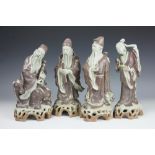 Four Japanese glazed earthenware figures, three sages and a geisha,