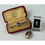 An amethyst set bar brooch, within yellow metal mount stamped '9ct',