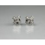 A pair of 18ct white gold and diamond set stud earrings,