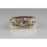 A seven stone ring in 18ct gold mount, set with seven colourless stones within a claw setting,