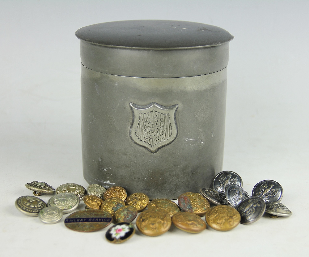 A pewter cigar case and cover, the cylindrical case baring coat of arms, 12cm high,