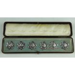 A cased set of six silver buttons, import mark for London 1904,