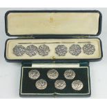 A cased set of six silver buttons, Levi and Salaman, Birmingham 1900, embossed with cherubs heads,