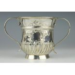 A silver porringer London 1760, makers mark 'SW', of typical half wrythen form with two strap,