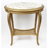 A French Louis XVI style gilt wood and gesso oval table, with marble top and caned under tier,