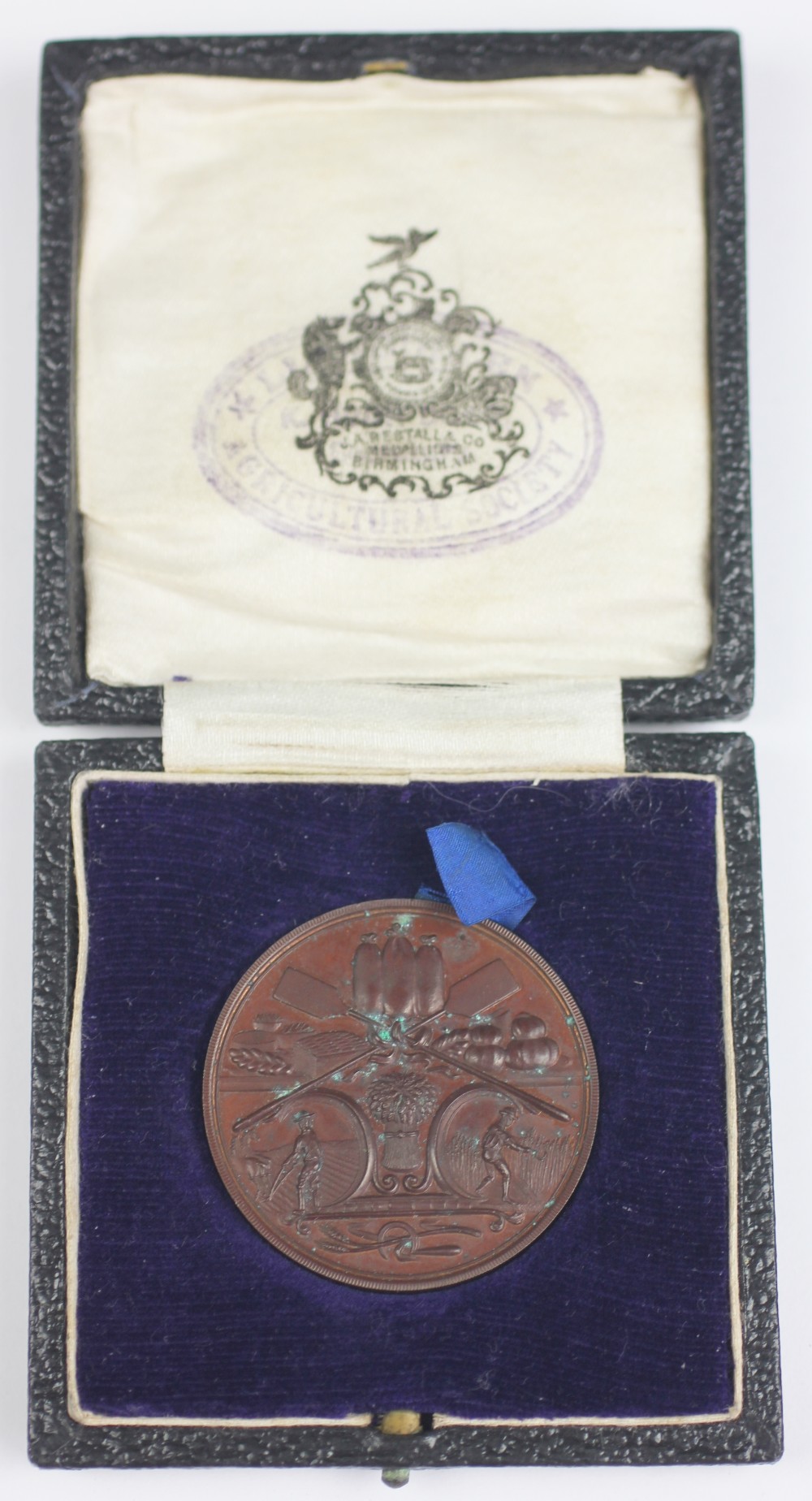 A Llangollen Agricultural Society medallion in case, engraved verso 'Best Two Brown Loaves, 1922, W.
