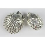 A novelty white metal walnut shell shaped case 4cm long and a small case in the form of a double