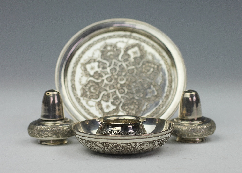 A Persian white metal condiment set, comprising a circular tray, two pepperettes and a salt, - Image 2 of 3