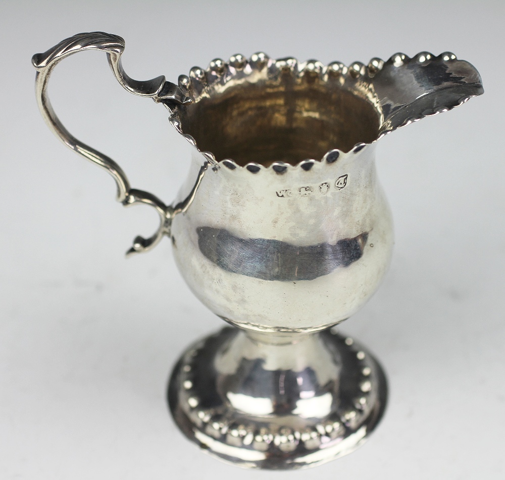 A George III silver pedestal milk jug 'WC' London 1774, of pedestal form and with crimped rim, - Image 2 of 2