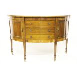 An Edwardian mahogany demi-lune sideboard, with one deep drawer and two cupboard doors,