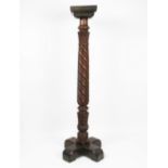 A carved mahogany torchere,