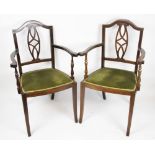 A pair of Edwardian inlaid mahogany salon chairs, with upholstered seats,