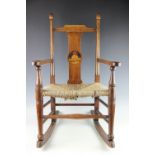 An Edwardian childs oak rocking chair,