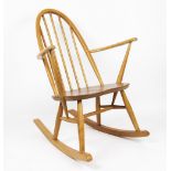 An Ercol light beech rocking chair, with hoop back and solid seat,