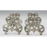 A pair of Victorian silver knife rests, London 1864, each of pierced floral and foliate form, 7.