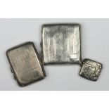 A silver cigarette case, Herbert Bushell & Son Ltd, Birmingham 1928, another silver cigarette case,