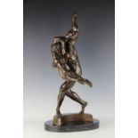 A contemporary bronze sculpture, modelled as two embracing dancers,