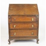 An early 20th century oak bureau, 103cm H x 74cm W x 45cm D, with an oak display cabinet,