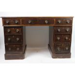 An Edwardian oak pedestal desk, with nine drawers, on plinth base,