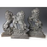 Three cast iron door porters / stops, in the form of lions rampant,