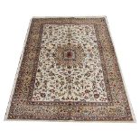A Kashmir rug, worked with a medallion and all over foliate design against an ivory ground,