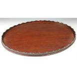 A 19th century mahogany oval tray, with serpentine gallery,