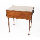 An Edwardian mahogany butterfly top Pembroke table, with drawer and serpentine leaves,