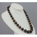 A Victorian banded agate bead necklace, the thirty-five spherical polished beads (measuring approx.