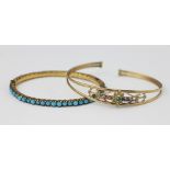 A yellow metal and semi-precious gem set bangle,