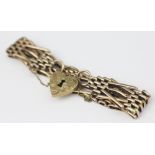 A decorative yellow metal Victorian bracelet, of decorative gate style and with X links,