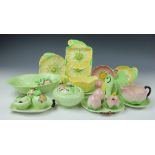 A collection of Carlton Ware floral and leaf moulded wares, to include; two condiment sets on trays,