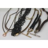 A collection of five assorted Victorian hair woven alberts and chains,