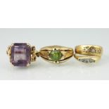 Four rings, to include; an amethyst set dress ring with bow and floral shoulders,