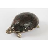 A late Victorian novelty tortoise table vesta, with white metal body and hinged tortoiseshell cover,
