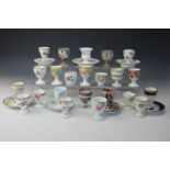 A collection of 19th century and later egg cups, to include seven examples with integral bases,