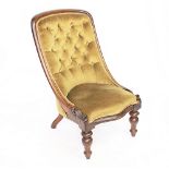 A Victorian walnut and upholstered nursing chair, with buttoned back, raised on two turned legs,