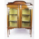 A Edwardian inlaid mahogany display cabinet, with two glazed doors, on tapered square legs,