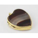 An agate set heart shaped locket, mounted to both sides with agate and within yellow metal mounts,