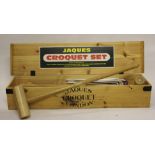 A modern Jaques croquet set, to include; four mallets, five hoops and four balls,