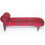 A Victorian chaise long with grey and red floral upholstery, on turned oak legs,