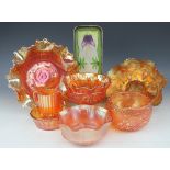 Seven pieces of carnival glassware to include a pedestal bowl with crimped rim,