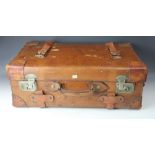 A vintage tan leather travelling case, with leather straps and side handles,