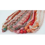 A collection of ten bead necklaces, to include; stick coral, carved wooden floral beads,