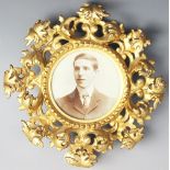 A 19th century circular gilt wood Florentine frame enclosing portrait of a gentleman,