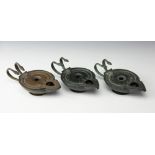 Three Egyptian style oil lamps, each of low form and with double snake handles, 17.