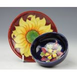 A Moorcroft Aquilegia pattern small bowl, yellow and claret flower against a cobalt ground,