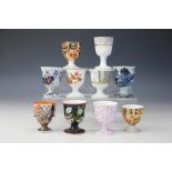 Ten 19th century Davenport porcelain and pottery egg cups,