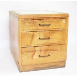 A vintage office pillar chest, of three graduated drawers, on plinth base,