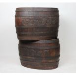 A pair of iron bound coopered oak jardinieres / log baskets, with fruiting vine detailing,